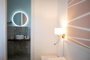 a bathroom with a toilet and a mirror at B&B MargAni Tropea in Tropea +64 photos