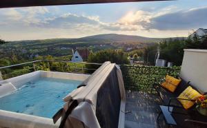 a hot tub sitting on top of a balcony at Hillside Cottage in Pécs