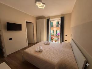 a bedroom with a bed with two shoes on it at La Rosa dei Venti in SantʼAntìoco