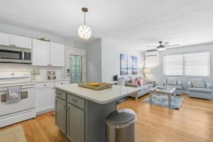 an open kitchen and living room with a counter top at Flagler Suites 3 in New Smyrna Beach +36 photos