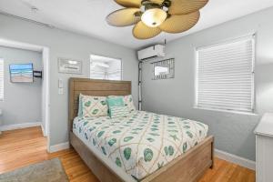 a bedroom with a bed and a ceiling fan at Flagler Suites 3 in New Smyrna Beach