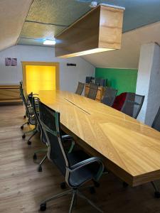 a large wooden table in an office with chairs at Rüütli kodumajutus in Paide