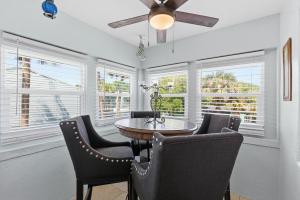 a dining room with a table and chairs and windows at Flagler Suites 2 in New Smyrna Beach +38 photos