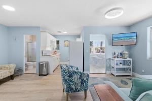 a living room with blue walls and a couch at Flagler Suites 4 in New Smyrna Beach