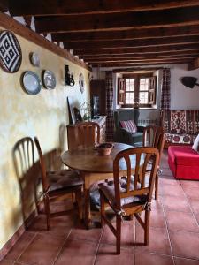 a dining room with a wooden table and chairs at Anticca Rural hasta 4 personas in Atauta