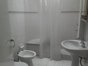 a bathroom with a sink and a toilet and a shower at Las Acacias De Santa Rosa in Santa Rosa