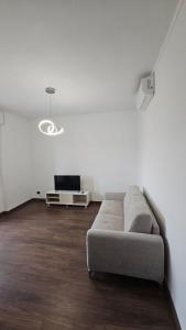 a living room with a couch and a tv at Casa Giovanni in Turin