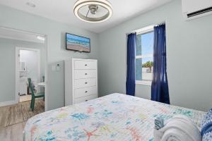 a bedroom with a bed and a window at Flagler Suites 1 in New Smyrna Beach