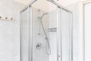 a shower with a glass door in a bathroom at Hostdomus - Villa Emma - Zoe e Ascanio in Alassio +21 photos