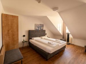 a bedroom with a large bed in a attic at Hotel Hechtplatz Self Check In in Zurich