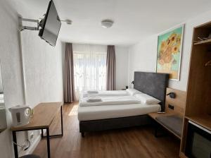 a hotel room with a bed and a desk at Hotel Hechtplatz Self Check In in Zurich