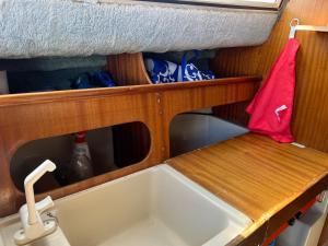 a kitchen sink with a red towel above it at Nuit insolite sur un bateau in Cap d'Agde +3 photos