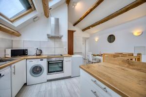 a kitchen with a washer and dryer at COLIVING - Private Suite Bathroom - Toilet in Saint-Jean-de-Gonville