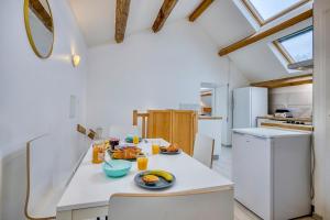 a kitchen with a table with food on it at COLIVING - Private Suite Bathroom - Toilet in Saint-Jean-de-Gonville +11 photos