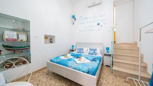a small bedroom with a bed and a staircase at La Casa Di Nicole by Rentbeat in Polignano a Mare