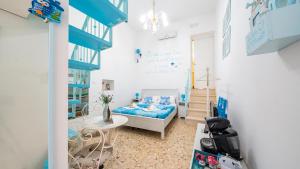 a small room with a bed and a staircase at La Casa Di Nicole by Rentbeat in Polignano a Mare