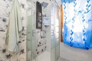 a bathroom with a shower with a glass door at Piccola Casa Melis in Capoterra +38 photos