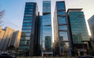 a group of tall buildings in a city at UH Suite The Seolleung in Seoul +37 photos