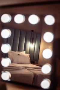 a bed in a room with a bunch of lights at Old Cinema Suites - Stylishly Decorated Retreat with Pool or Jacuzzi by the Sea in the Heart of Laganas Βy Villa Mana Gers in Laganas