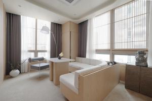 a living room with a couch and a table at UH Suite The Seolleung in Seoul