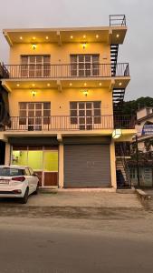 a white car parked in front of a building at Grace place in Vagamon