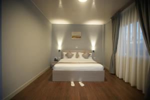 a bedroom with a bed and a large window at Haile Hotel Debre Birhan in Debre Birhan +20 photos