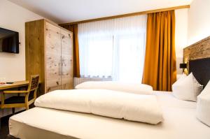Posteľ alebo postele v izbe v ubytovaní Hotel Garni Persutt