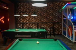 a billiard table in a room with a game room at Hotel Tarnovia in Tarnów