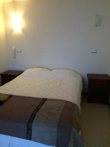 En eller flere senge i et værelse på Departamento Costa Mansa