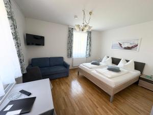 a bedroom with a bed and a blue couch at Seemüllnerhaus in Millstatt