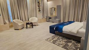 a hotel room with a bed and two chairs at Lavera in Hotel - Rowibeh Hotels in Riyadh +56 photos