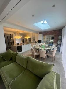 a living room with a green couch and a table at 4 Bayswater in New Brighton