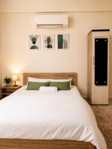 a bedroom with a large bed with a white comforter at Live Easy in Siliguri +7 photos