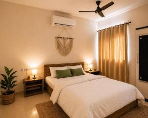 a bedroom with a bed and a ceiling fan at Live Easy in Siliguri