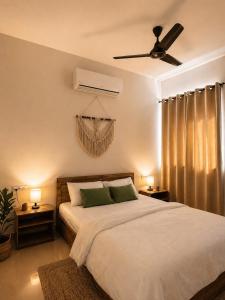 a bedroom with a bed and a ceiling fan at Live Easy in Siliguri