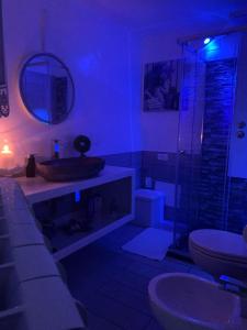 a bathroom with a toilet and a glass shower at Bed & Breakfast Dimora Felice in Ostuni