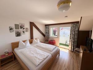 a bedroom with a bed and a large window at Seemüllnerhaus in Millstatt