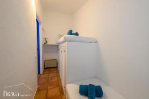 a bathroom with a tub with blue towels on it at Can Rino - Vistas panorámicas I piscina I tenis I terraza I Brava Experience in Cadaqués +40 photos