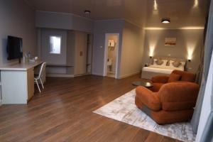 a living room with a bed and a couch and a chair at Haile Hotel Debre Birhan in Debre Birhan