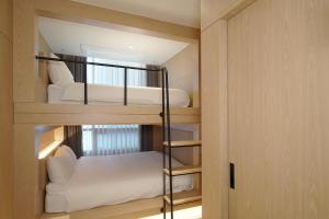 a small room with two bunk beds in it at UH Suite The Seolleung in Seoul
