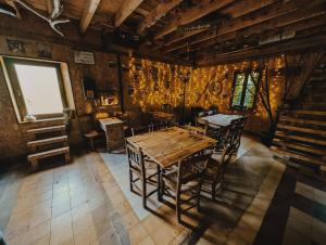 a dining room with a wooden table and chairs at La Posada Cercedilla in Cercedilla