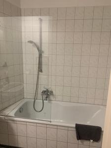 a bath tub with a shower in a bathroom at Altes Forstamt in Xanten