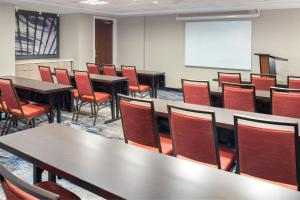 a classroom with tables and chairs and a whiteboard at Fairfield Inn & Suites by Marriott Cape Cod Hyannis in Hyannis +38 photos