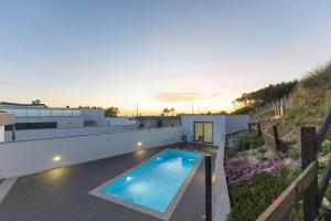 a swimming pool on the roof of a house at Dunes Beach House with Ocean Views in Viana do Castelo