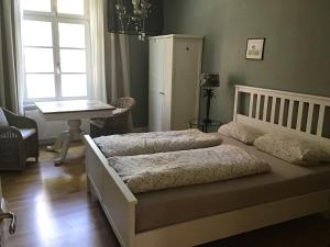 a bedroom with two beds and a table and a desk at Altes Forstamt in Xanten