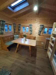 a room with a wooden table in a cabin at Blockhütte bei den Hühnchen in Rötz +21 photos