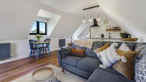 a living room with a couch and a kitchen at Ferny Retreat in Bromyard