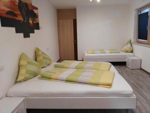 two beds in a room with two bedsvisor at Ferienwohnung Mair in Umhausen