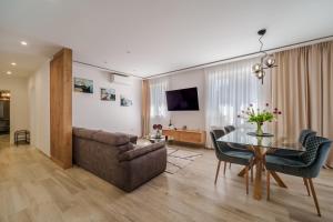 a living room with a couch and a table at Apartments Barbara Kraljevica in Kraljevica
