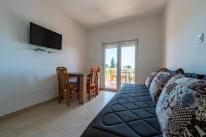 a living room with a couch and a table at Benelux Apartments Bar in Šušanj